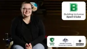 Person smiling while seated in a wheelchair. Building Inclusive Sport Clubs logo and partner logos appear on the right.