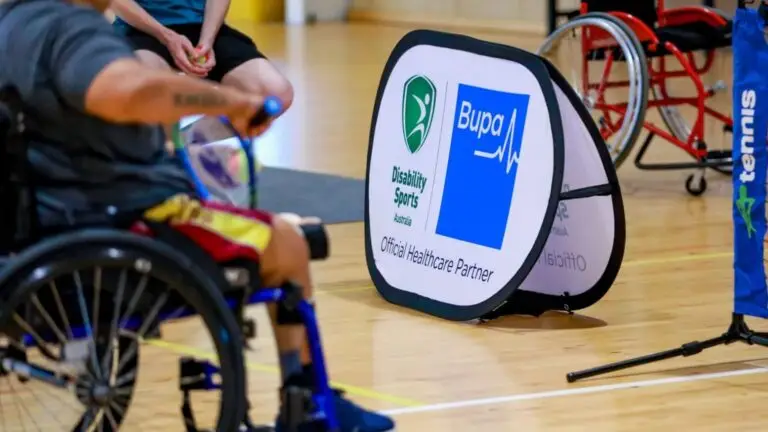 Disability Sports Australia and Bupa sign reading “Official Healthcare Partner” at indoor sport session